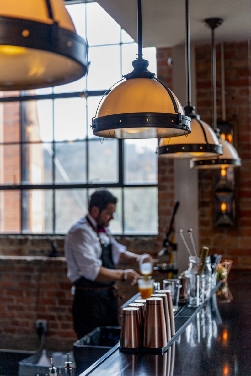 man making cocktails at a bar