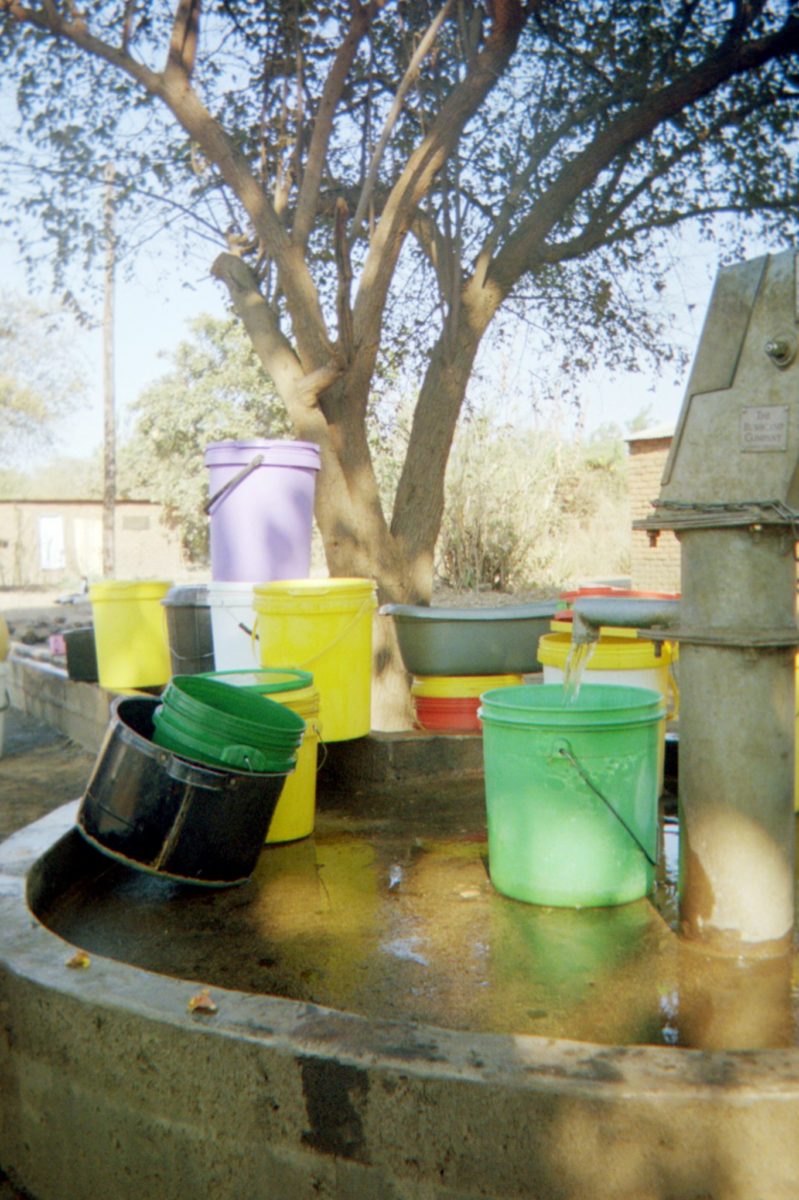 colorful water buckets near the bushcamp company's clean water project wells