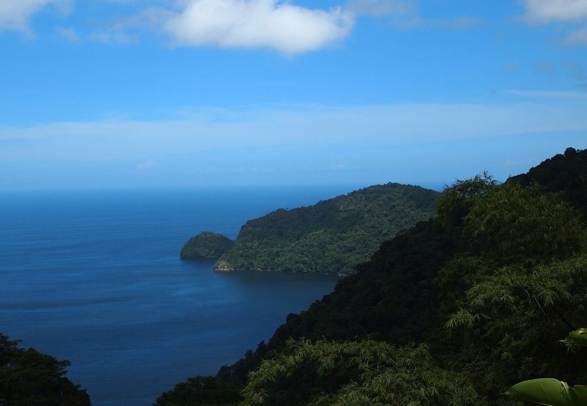 Dark mountains with a vast blue ocean in the distance