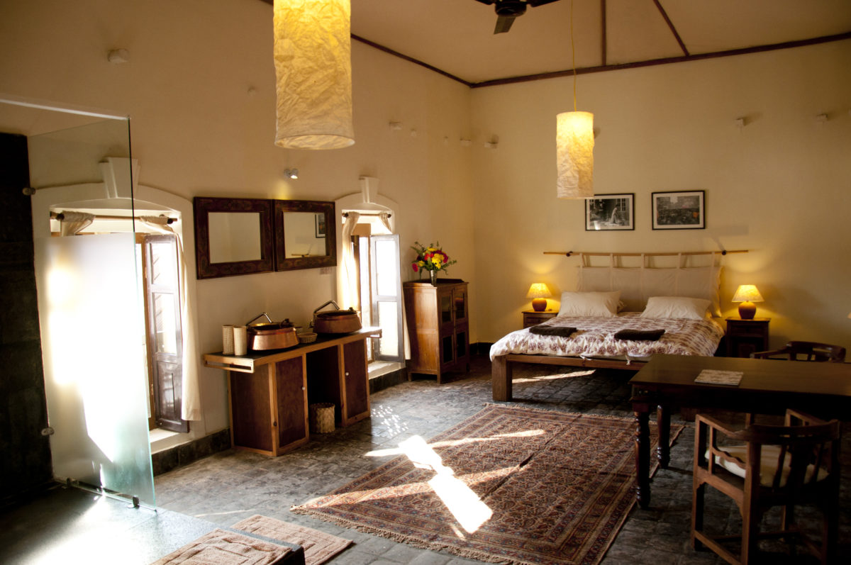 a hotel room with sunlight pouring through cracked windows in kathmandu, nepal.