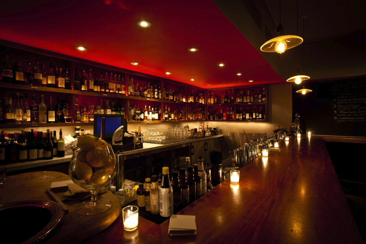 a long, dark bar with a blood red ceiling