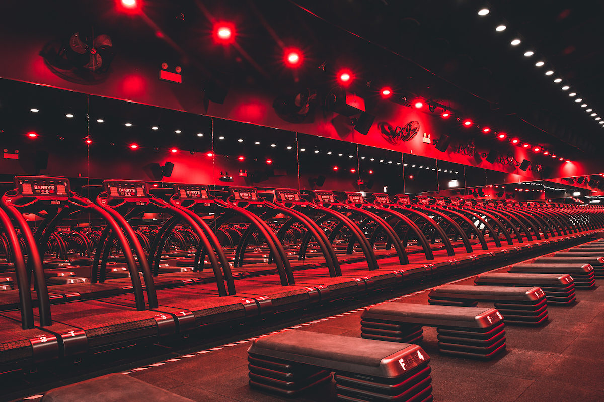 a series of treadmills in a red-lit room