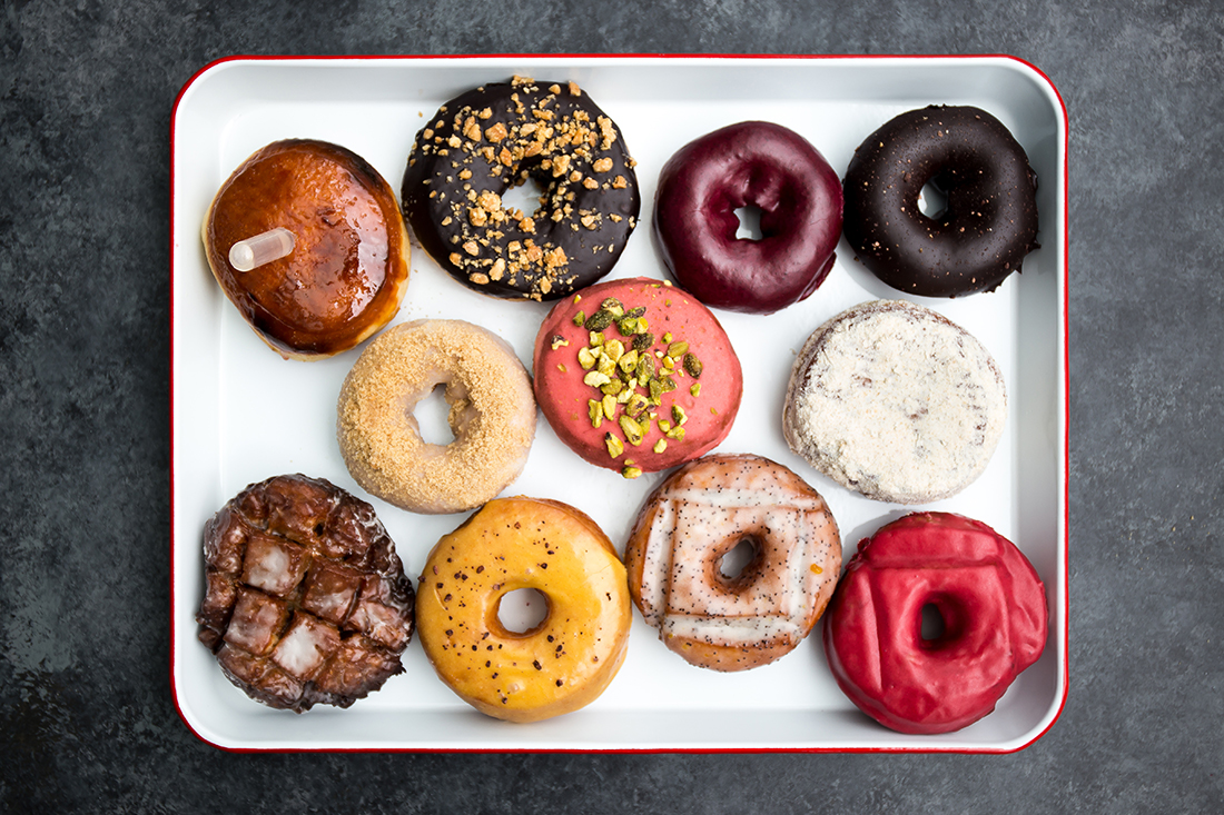 a plate of colorful donuts