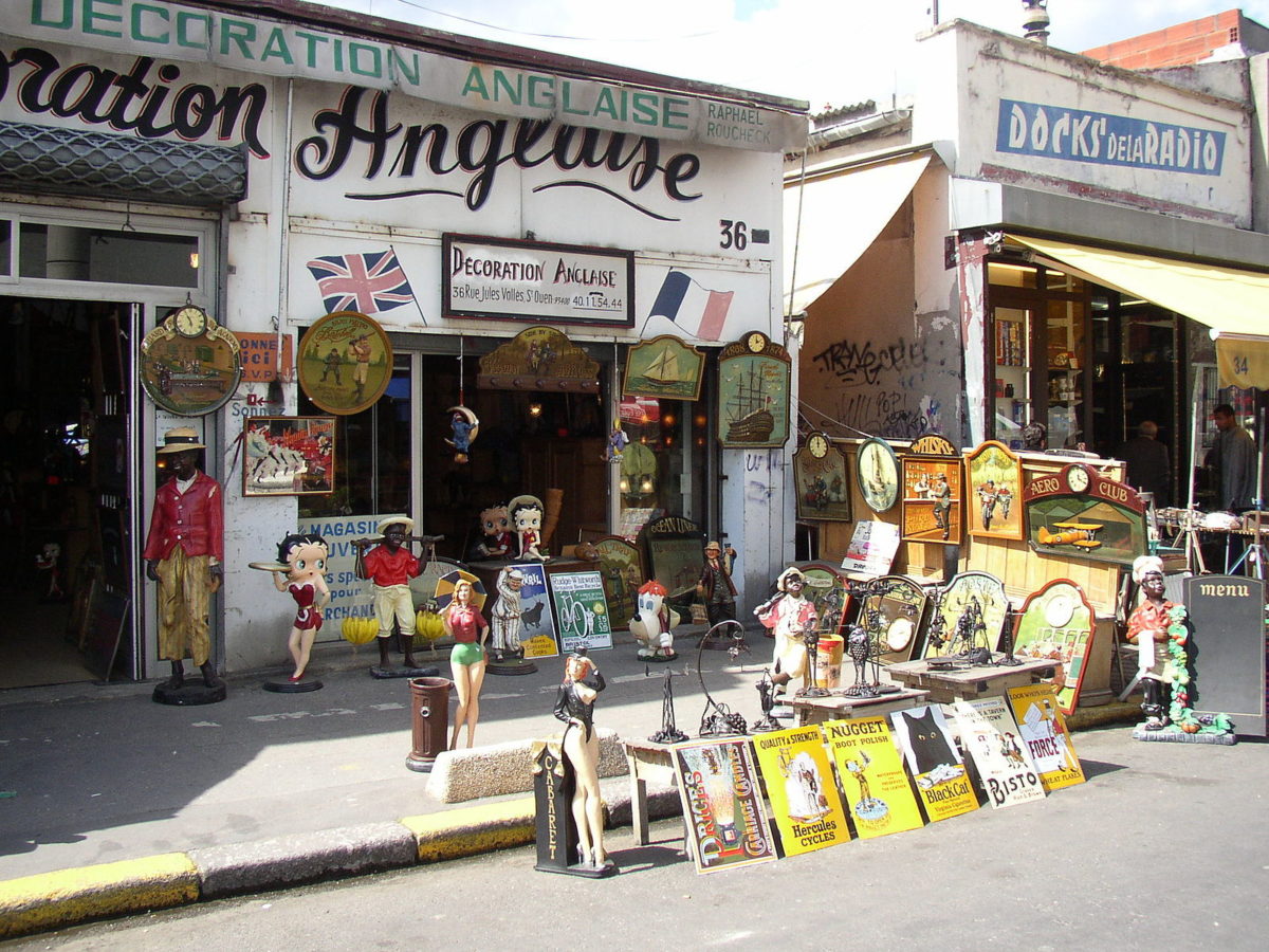 rows of artwork lined along the street outside a storefront