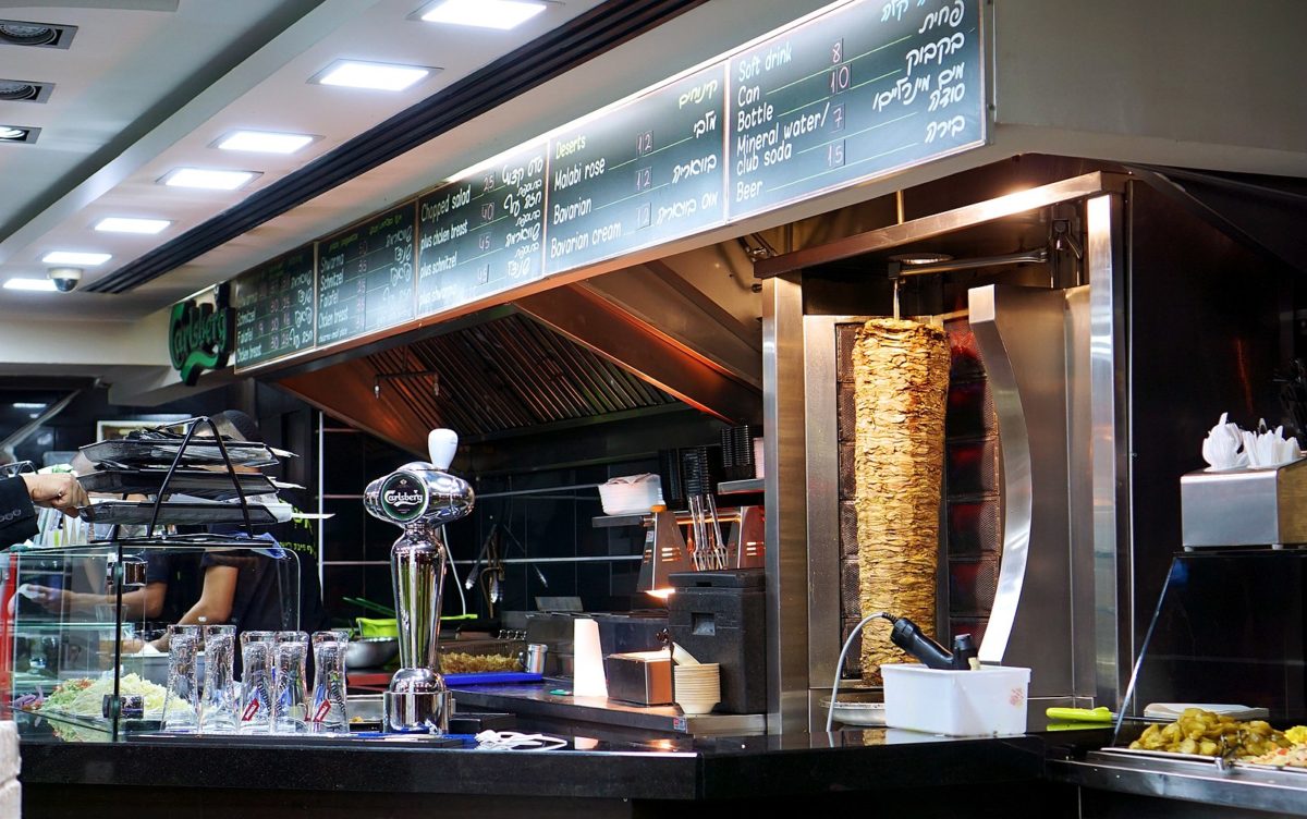 the counter of a food stand selling shawarma