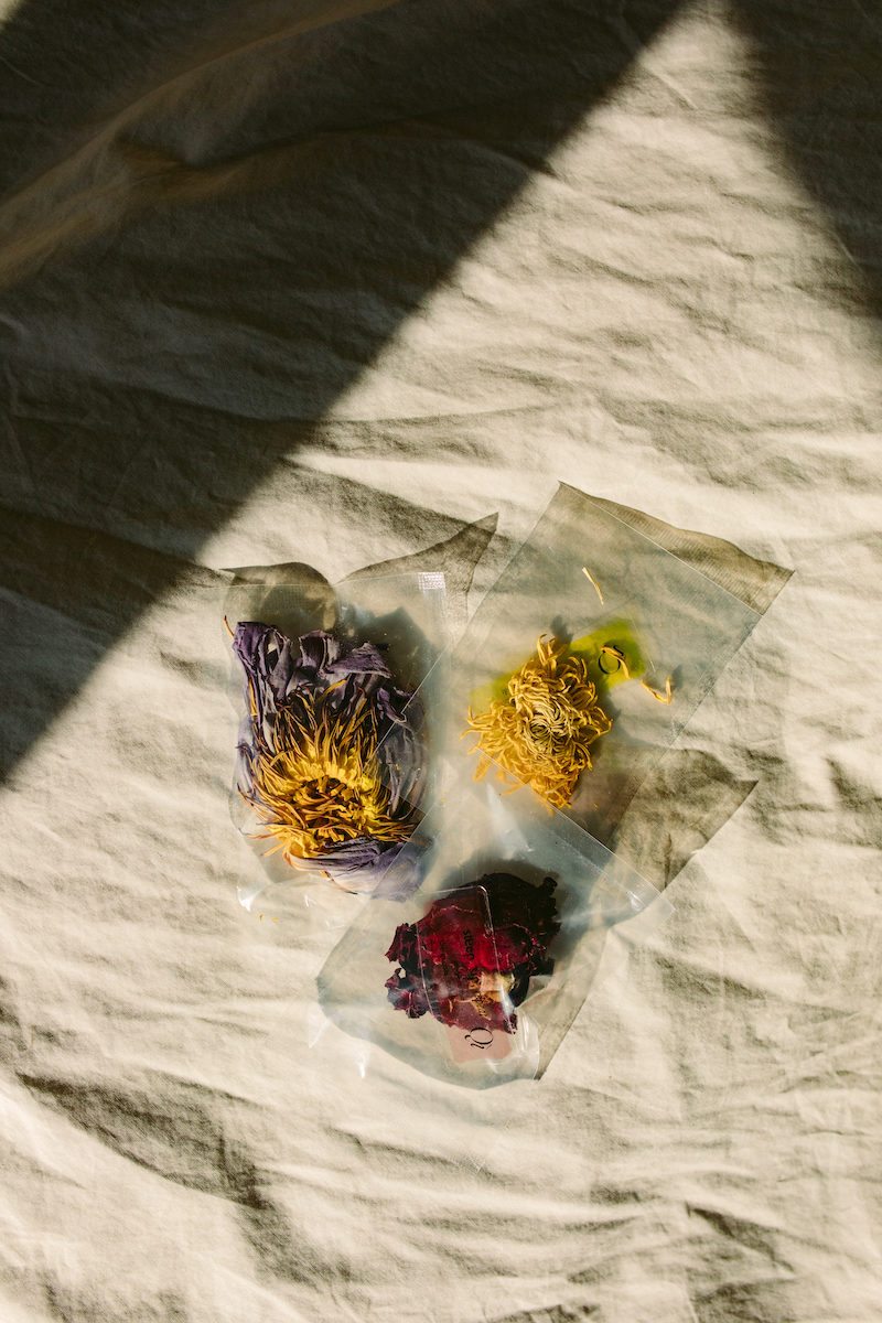 packets of floral tees on a bed