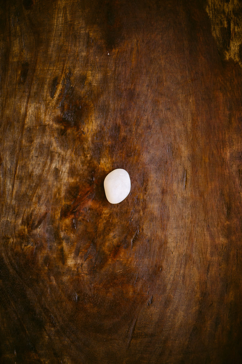 a white stone on wood floor