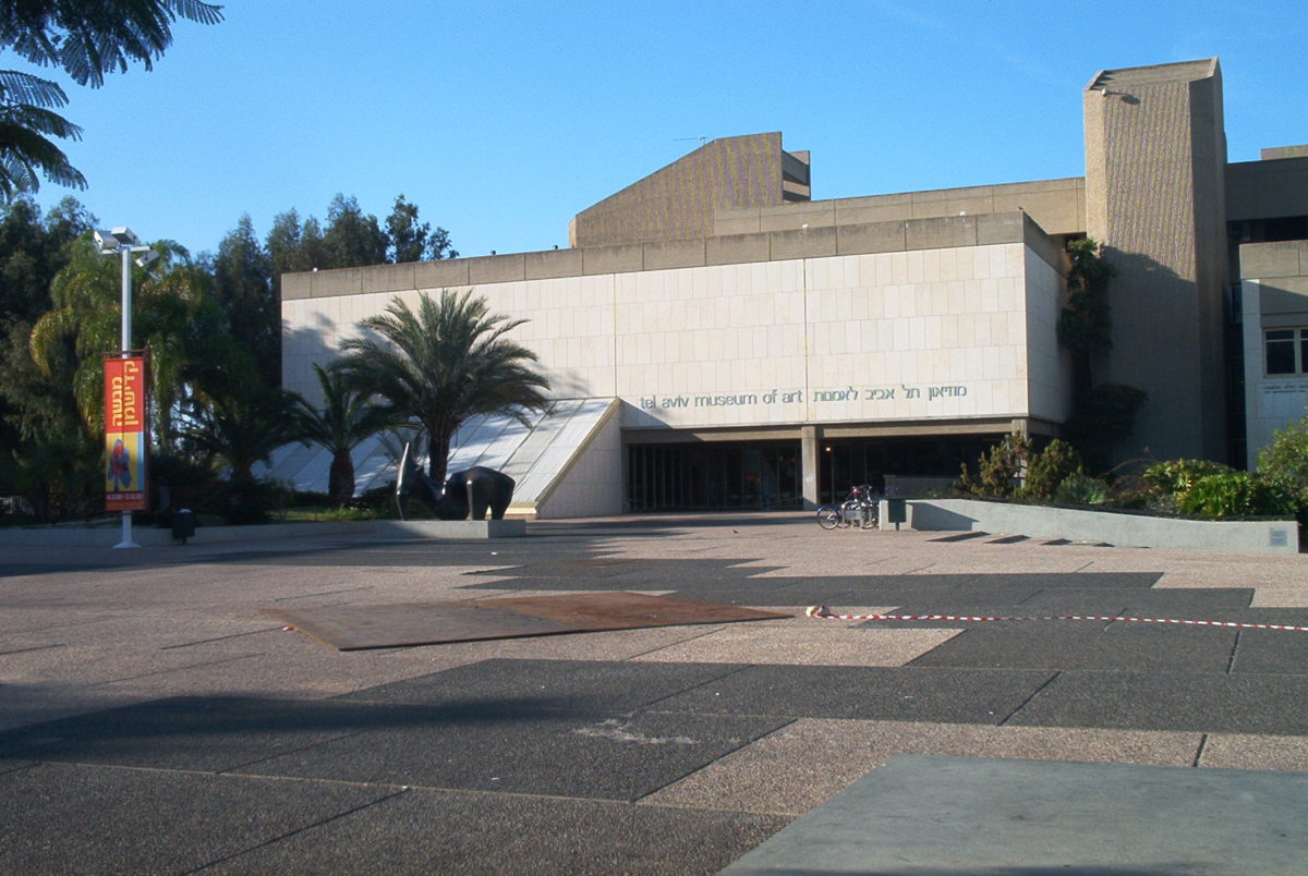 a large white geometrical building on a sunny day