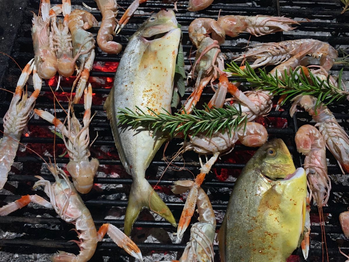 whole fish and herbs on a grill