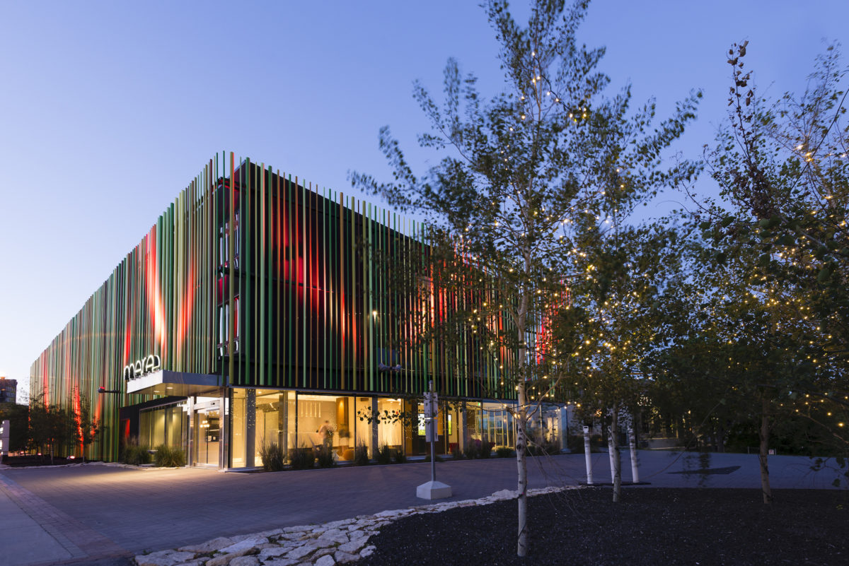 outside a colorfully lit building in the evening