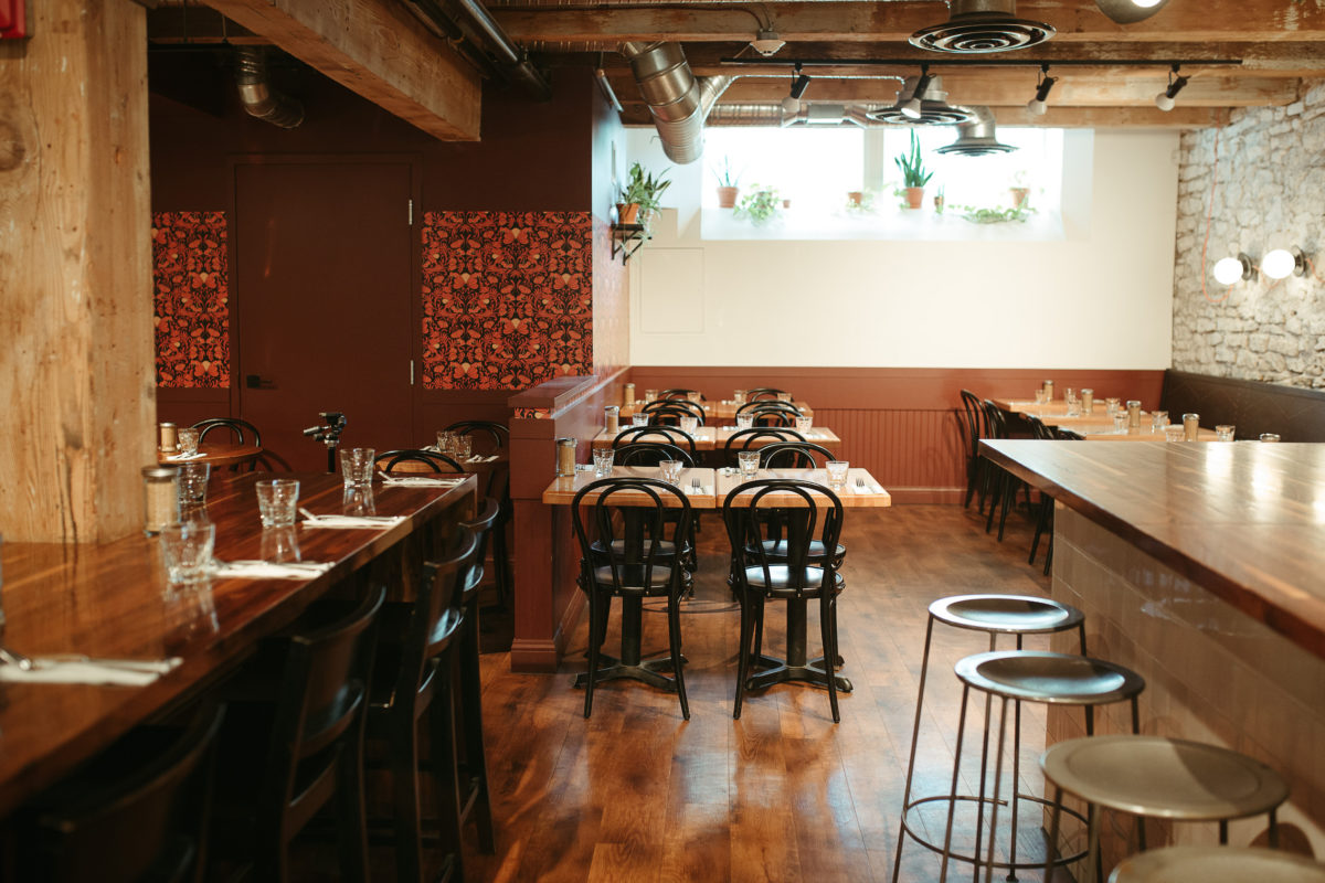 tables and chairs in a naturally lit restaurant