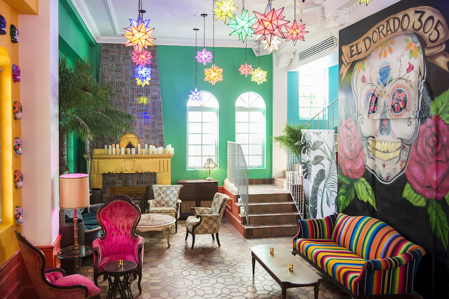 a colorful room with eclectic furniture and bright lanterns in the daytime