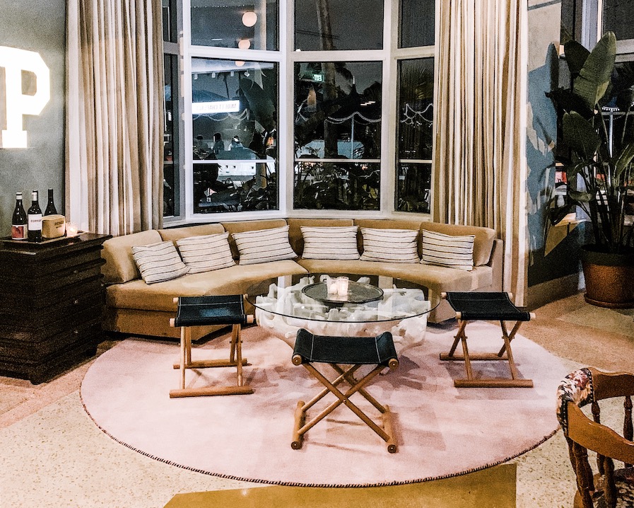 a dark blue couch surrounded by pink decor