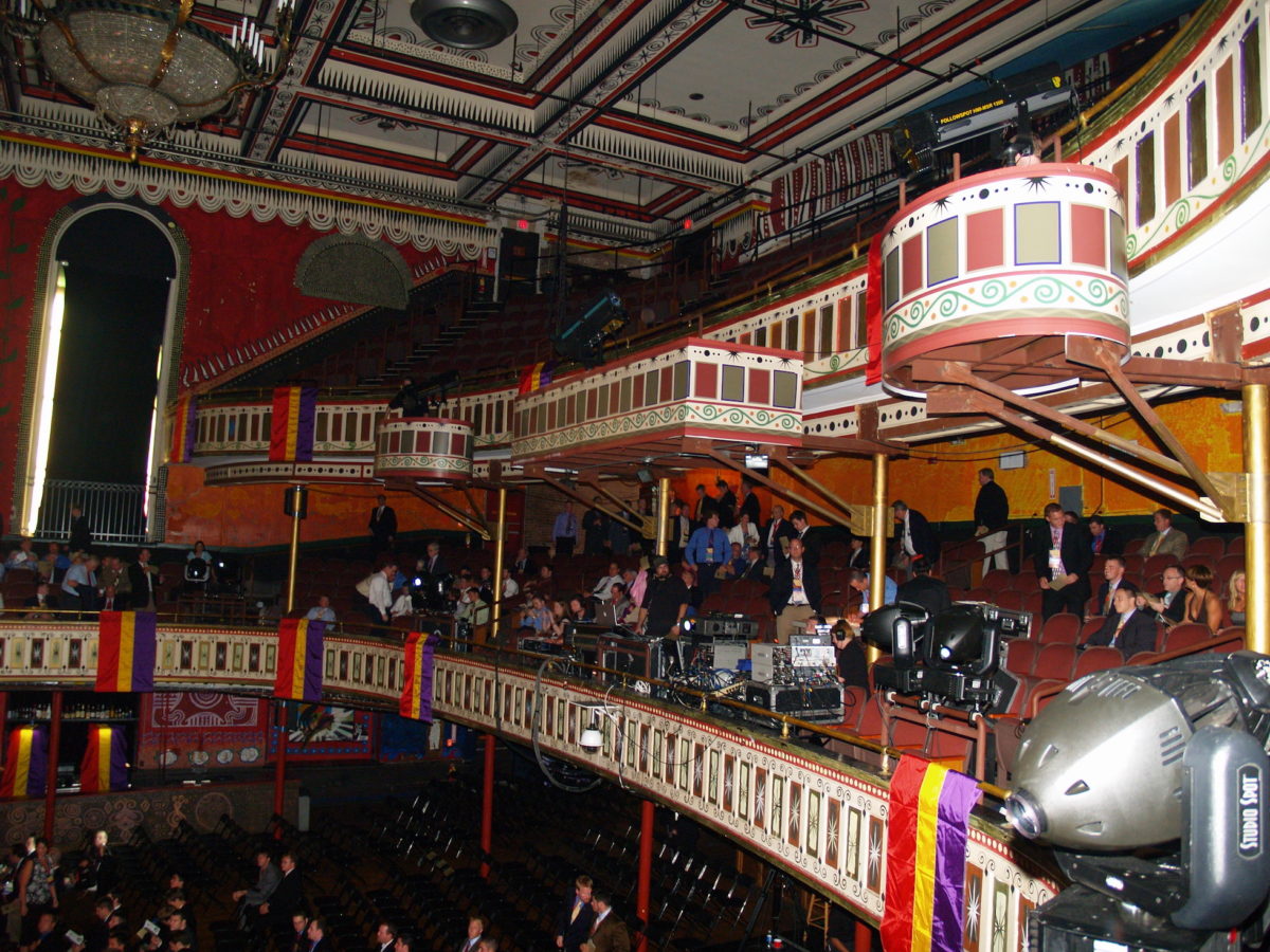 people sitting in balconies in a dimly-lit venue