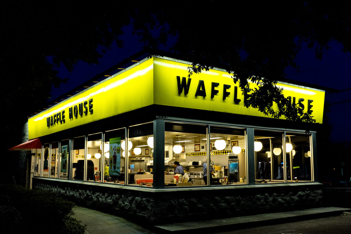 a glowing waffle house at night