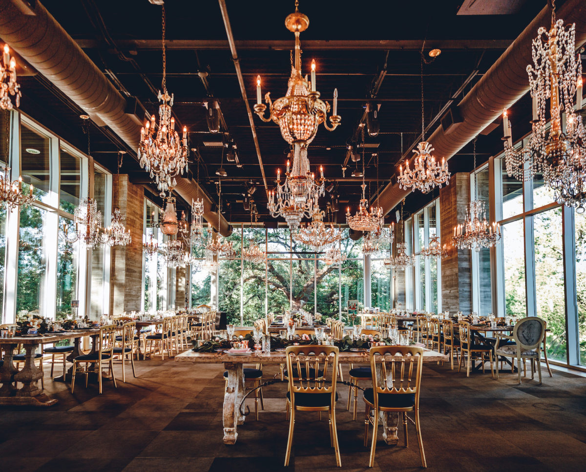 a large ornate room with big windows and chandeliers