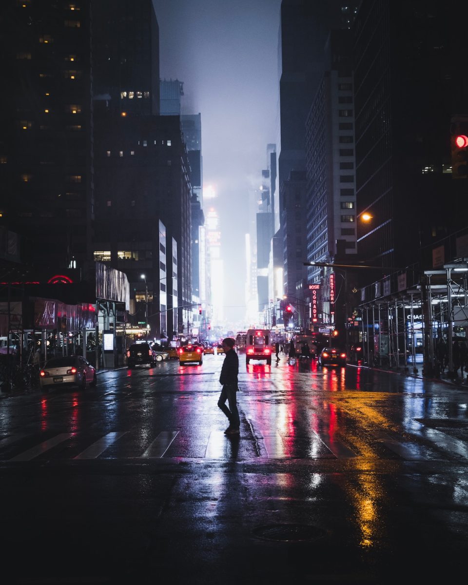 rainy New York street with Times Square lit up in the distance