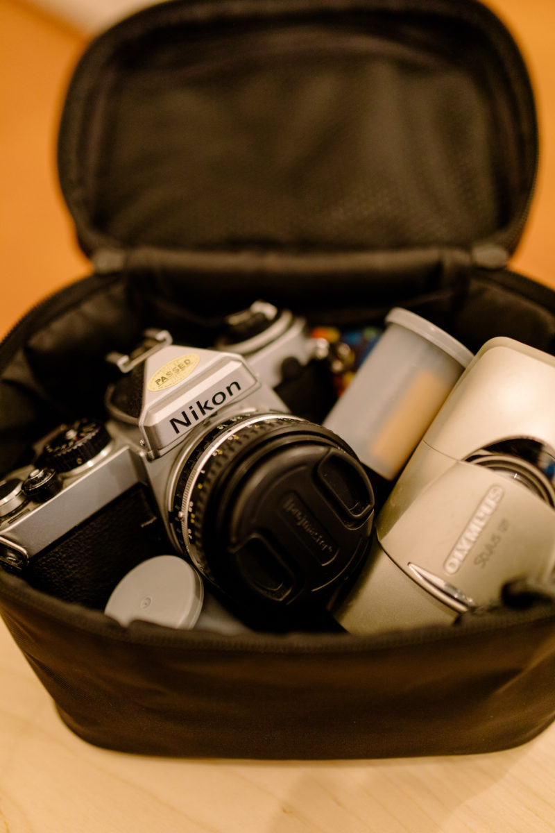 a camera and rolls of film in a bag