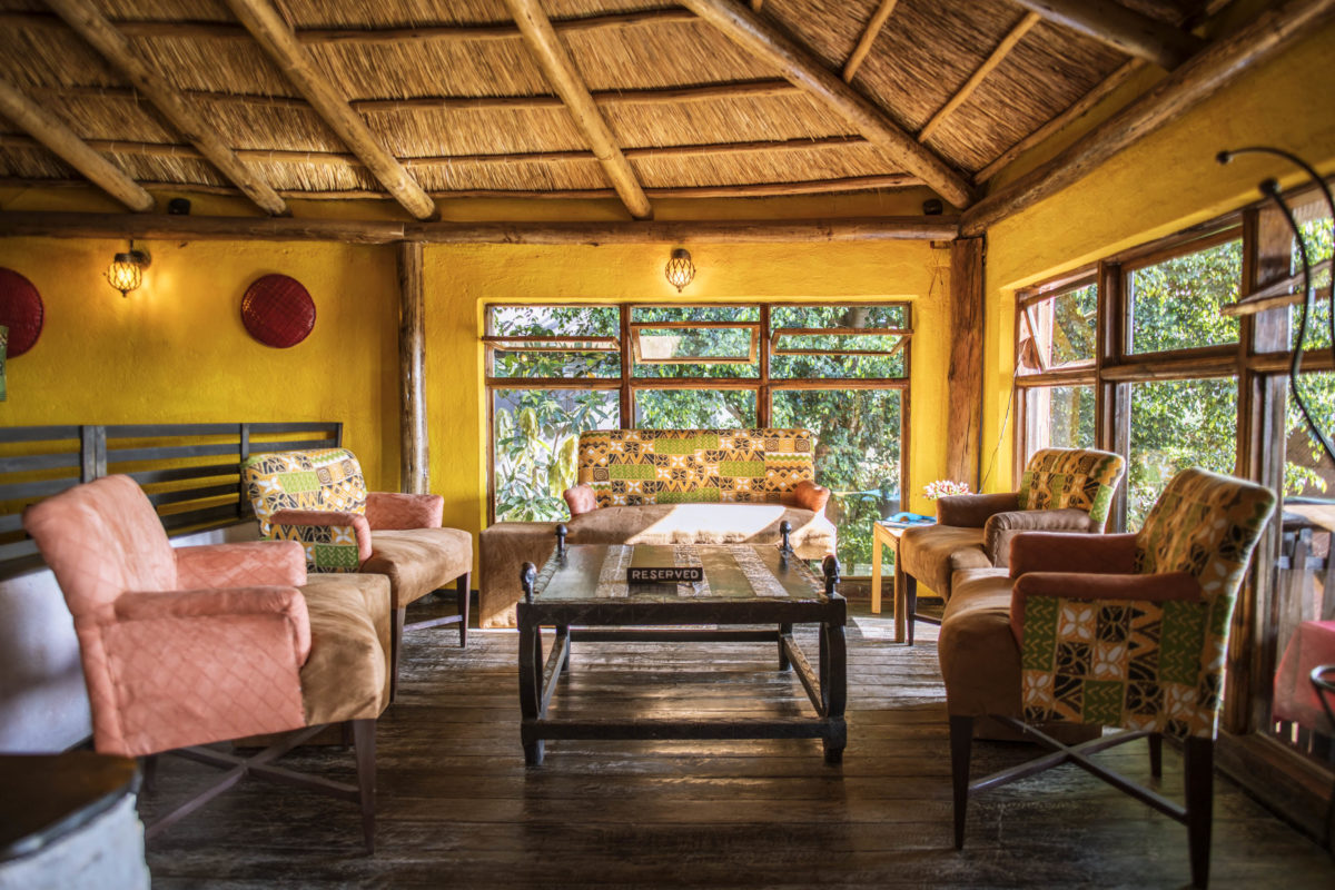 comfortable couches and chairs sitting around a table in a sunlit room