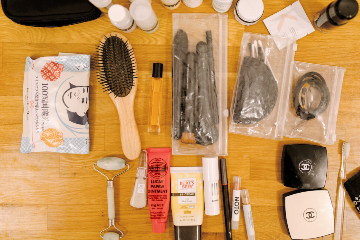 a hairbrush, makeup brushes, makeup, and other toiletries