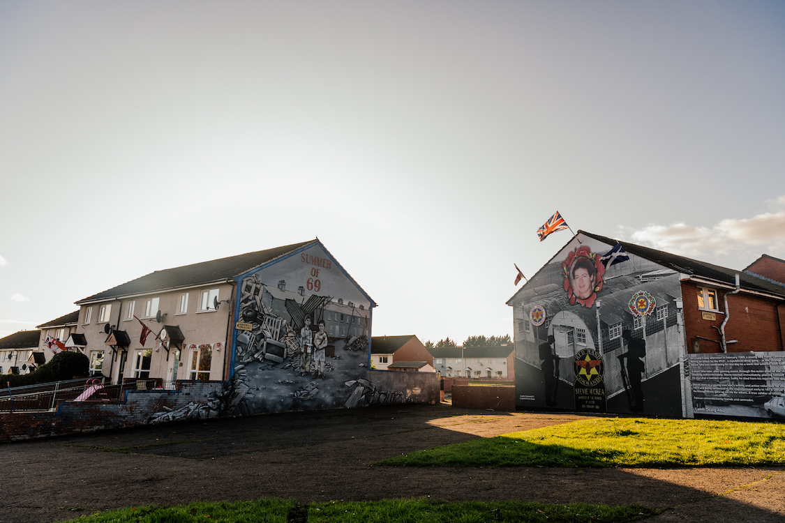 two houses decorated by graffiti at sunrise