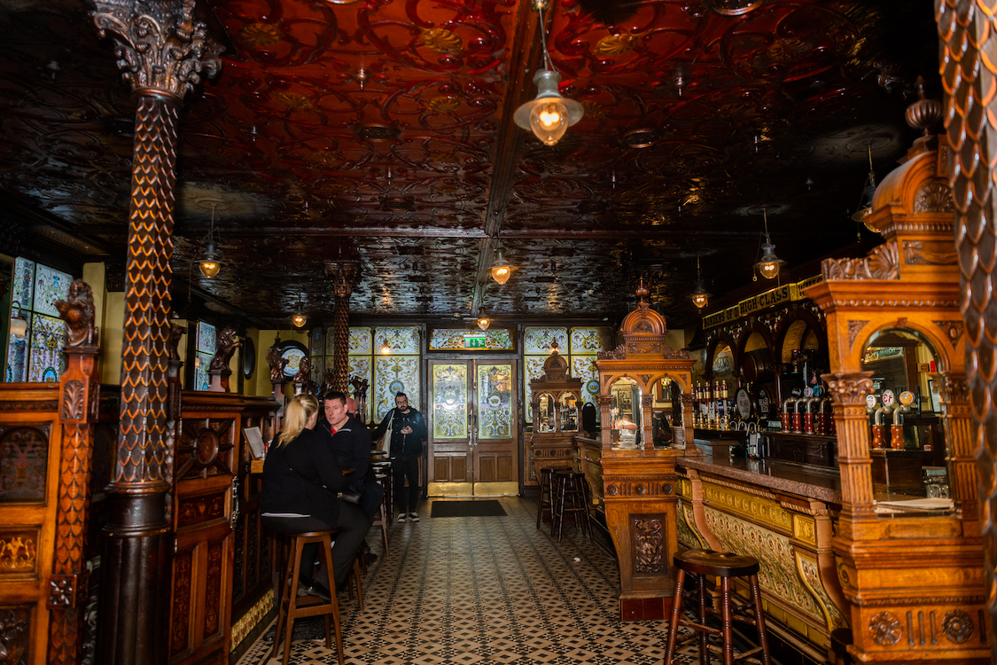 a large antique bar room populated by a few patrons