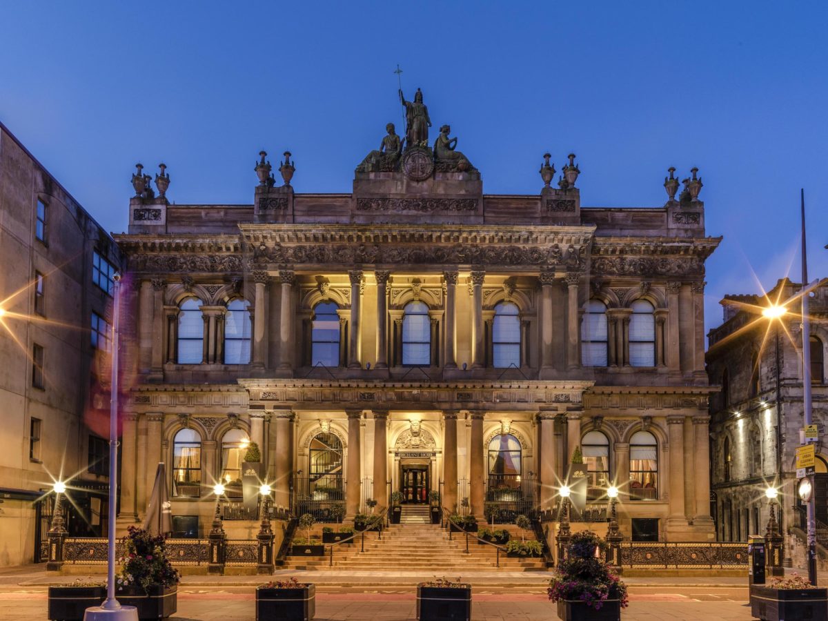 a giant, palace-like hotel with a grand staircase at night