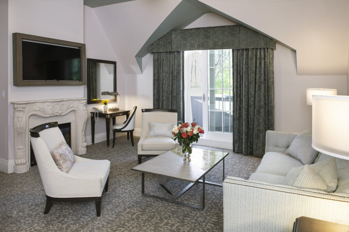 the interior of a modern hotel room with a fireplace