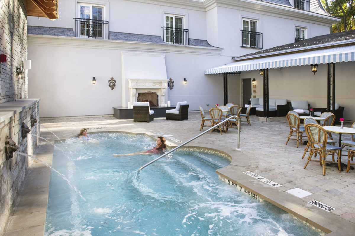 people lounging by an outdoor pool