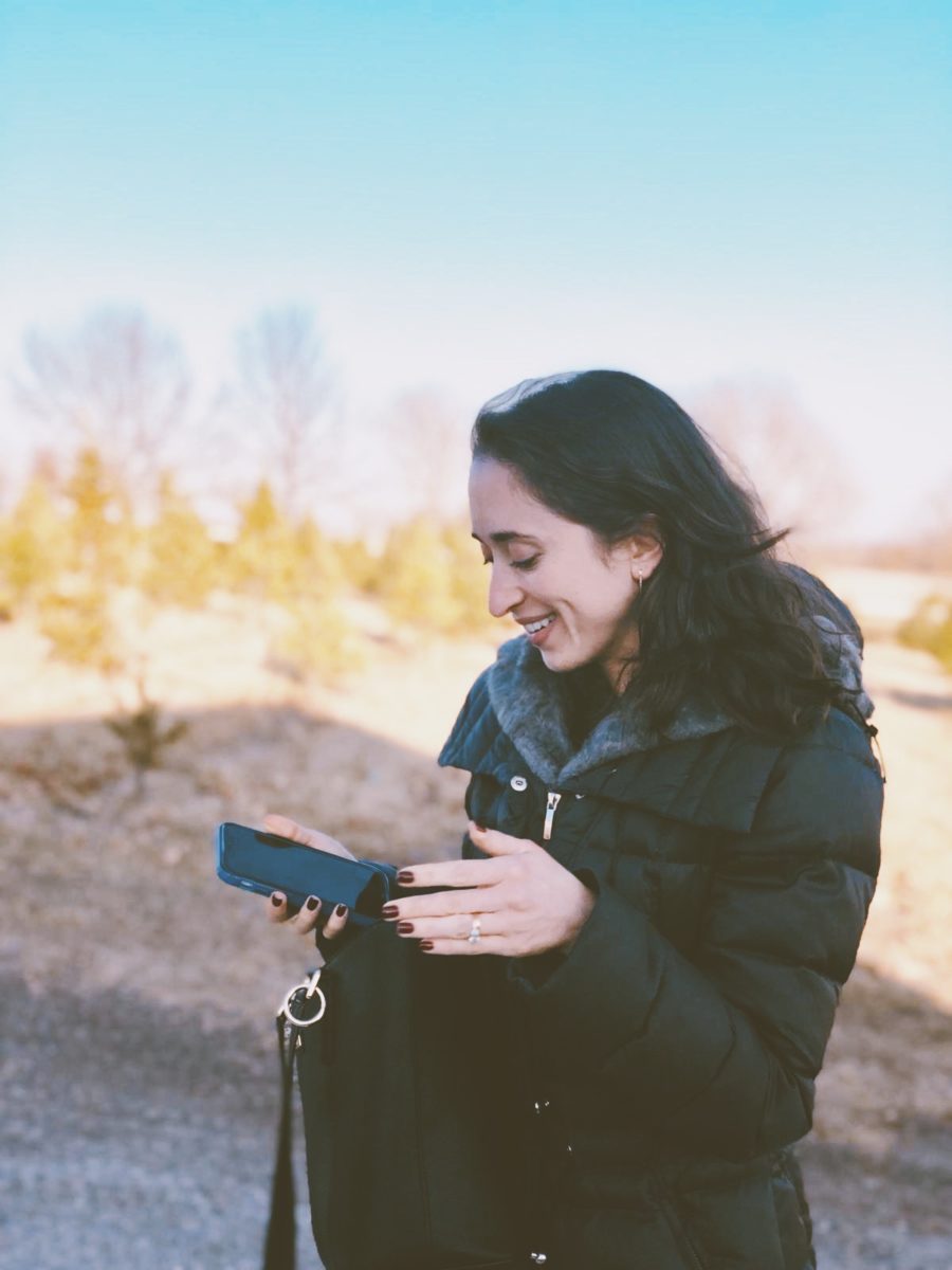 katie gluek standing outside with her phone