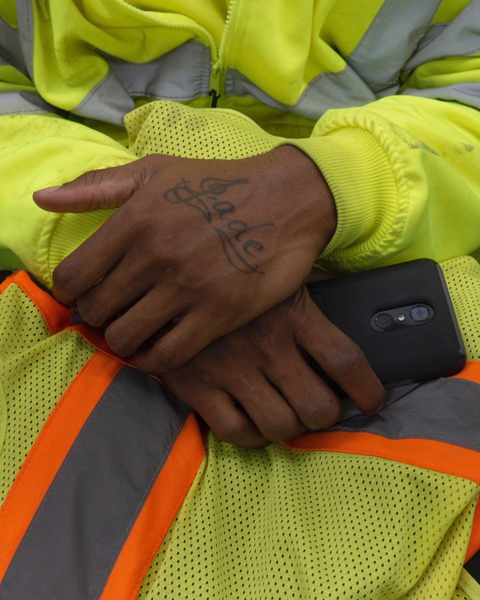 folded hands with a tattoo reading "Jade"