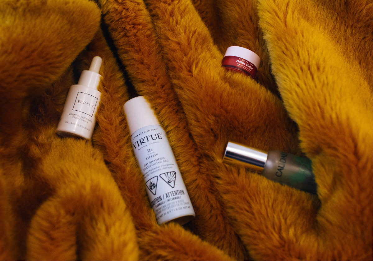 bottles of beauty essentials on a fur textured background