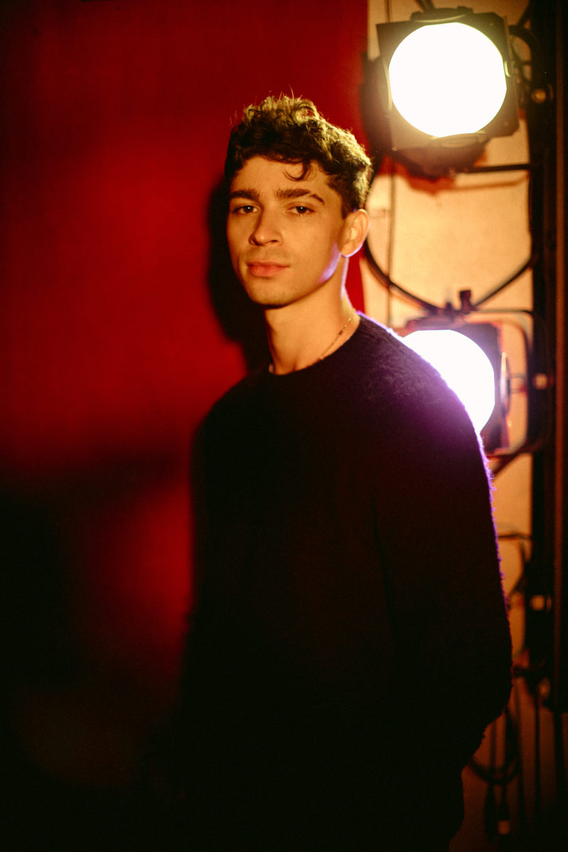 a man posing in front of stage lights