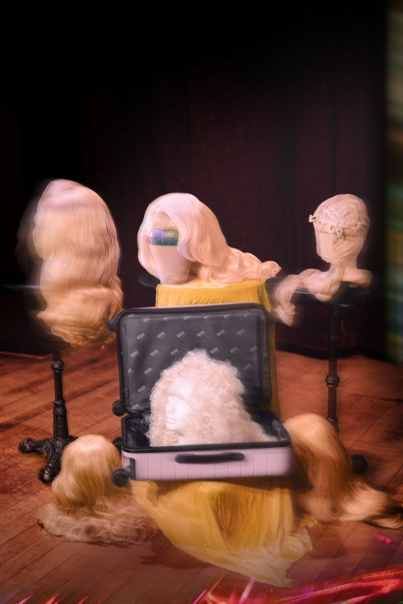 several wigs displayed on a stage