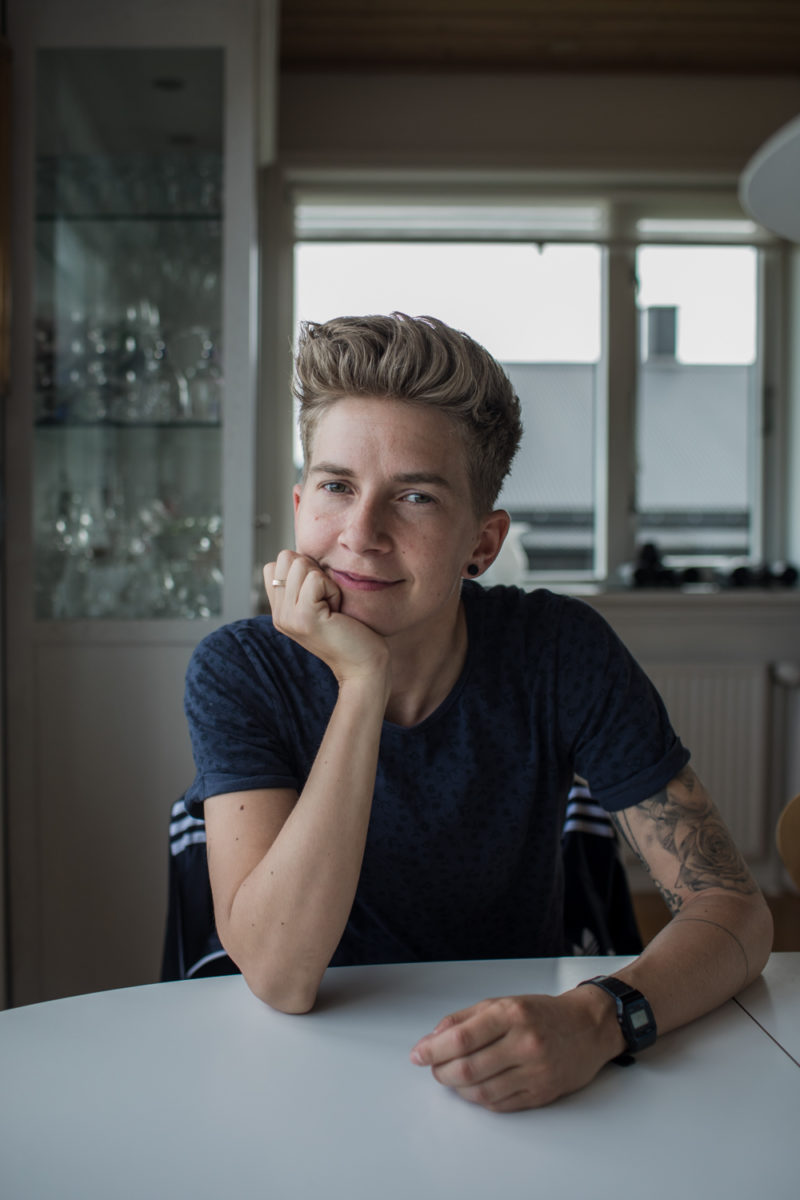 a woman with cropped hair at a table