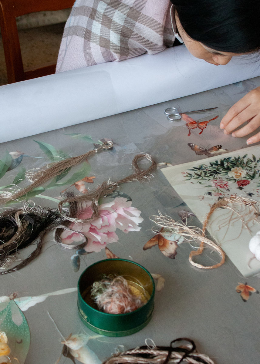 a person working on embroidery