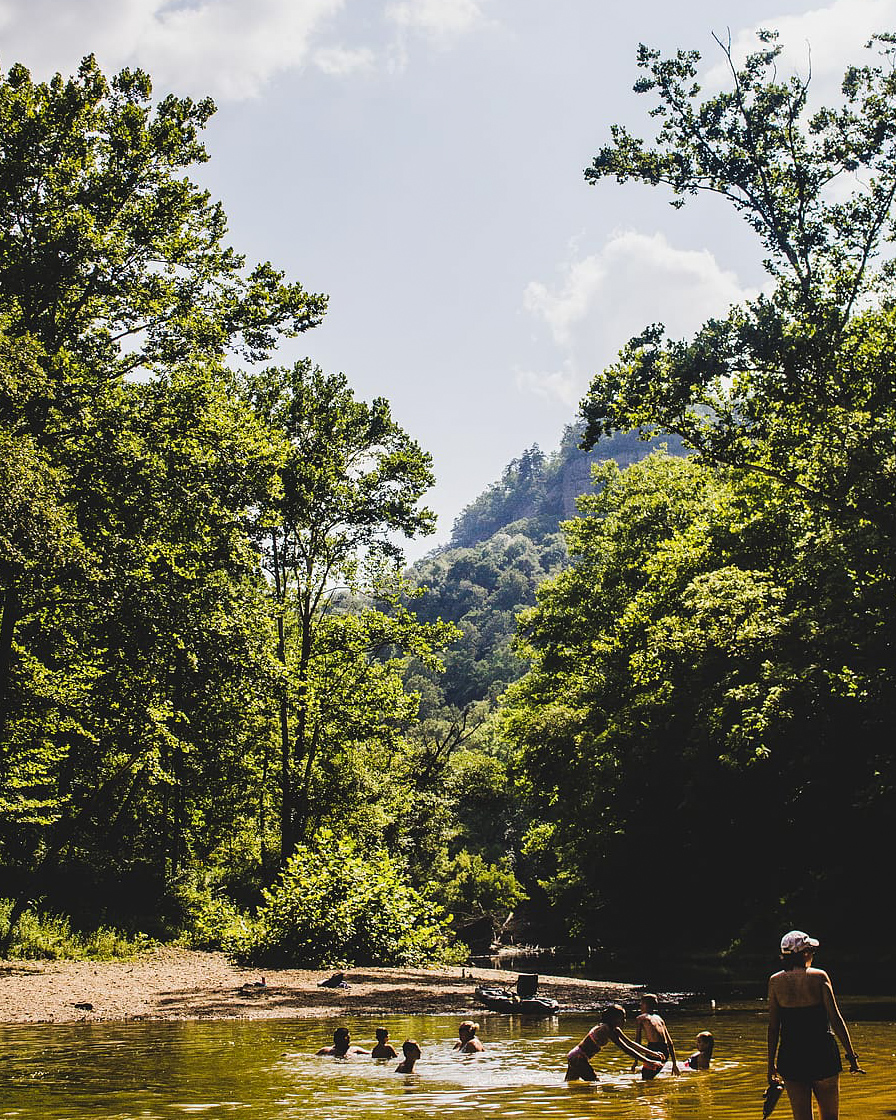 people playing in a creek