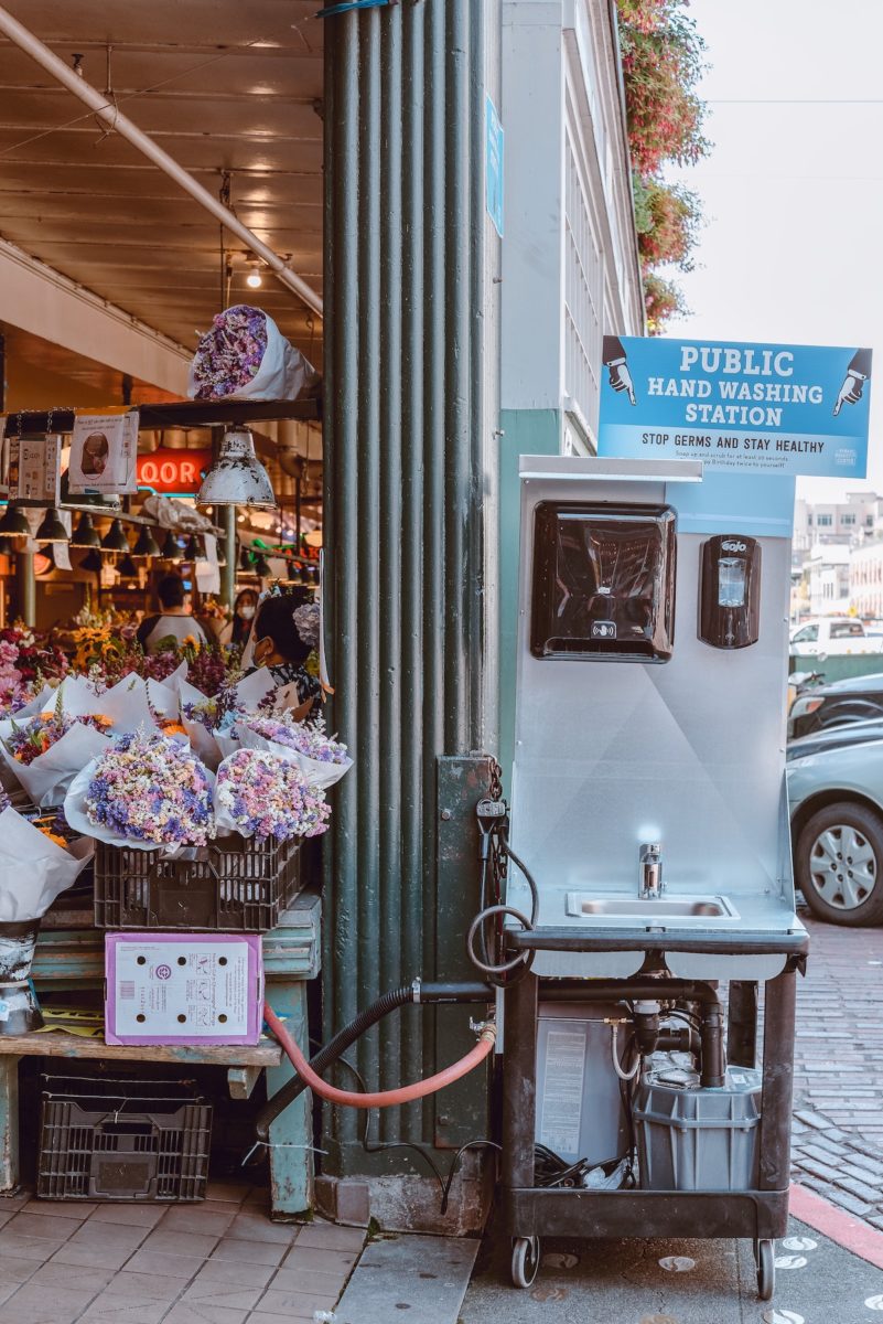 portable hand washing station outside of a flower market