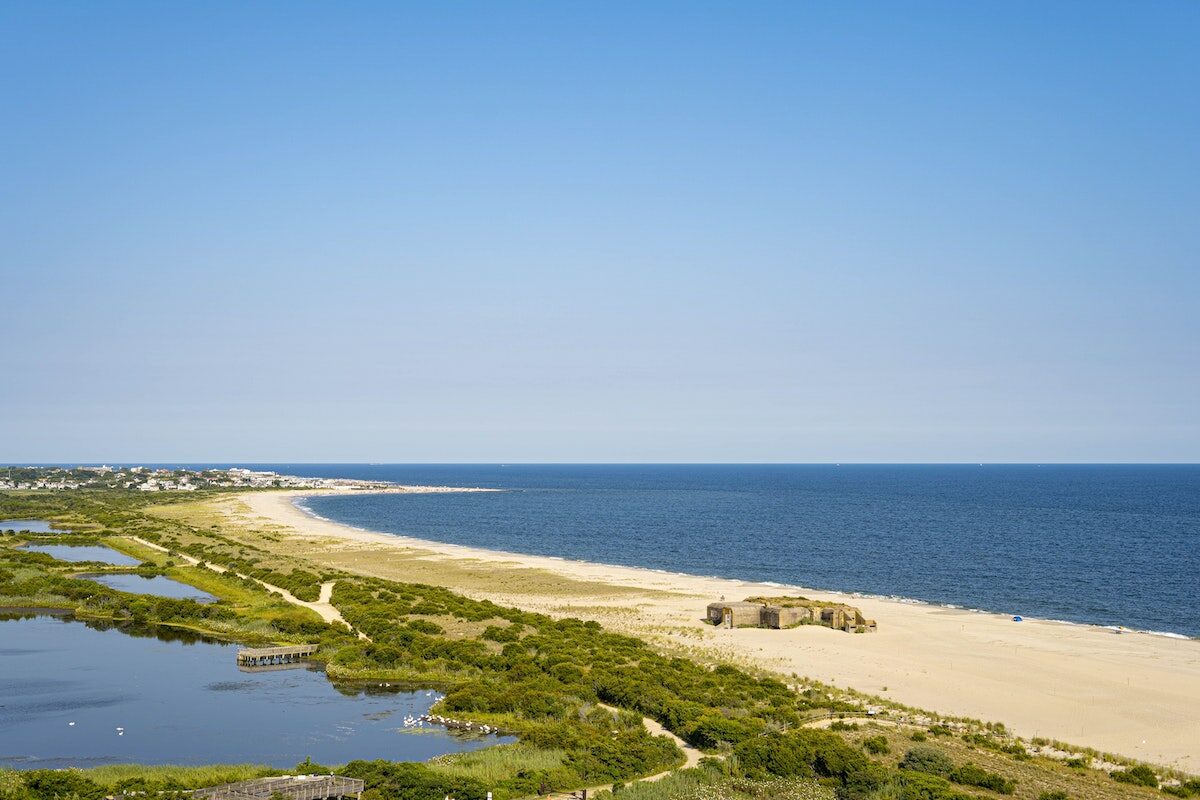 aerial view of a cape jutting into the blue ocean