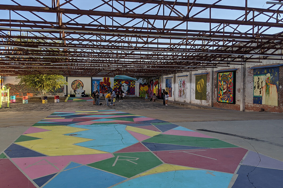 a long covered alleyway filled with murals