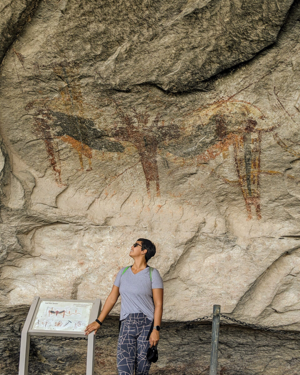 a woman looking at cave art