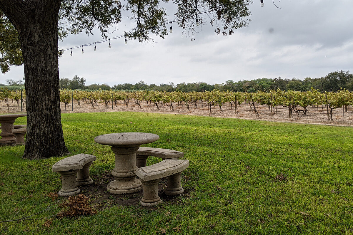 a stone bench near a winery