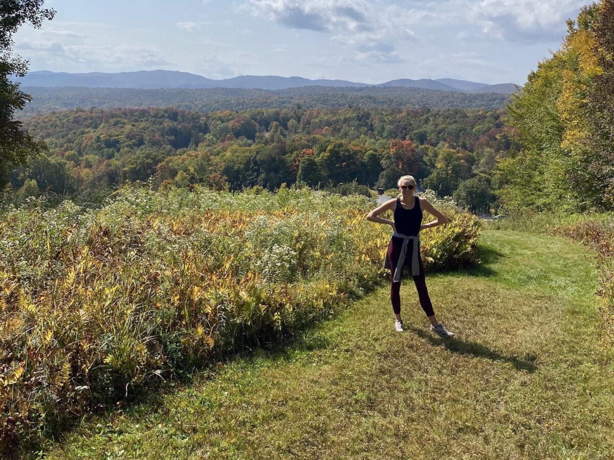 a woman standing on a hill