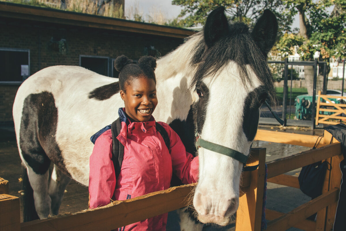 a young girl with a horse