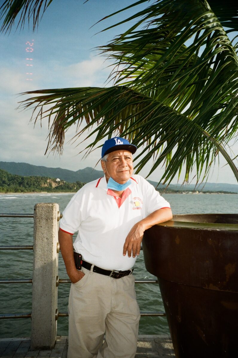 an older man posing at the beach